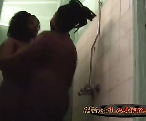 African lesbians kissing and washing each other in shower